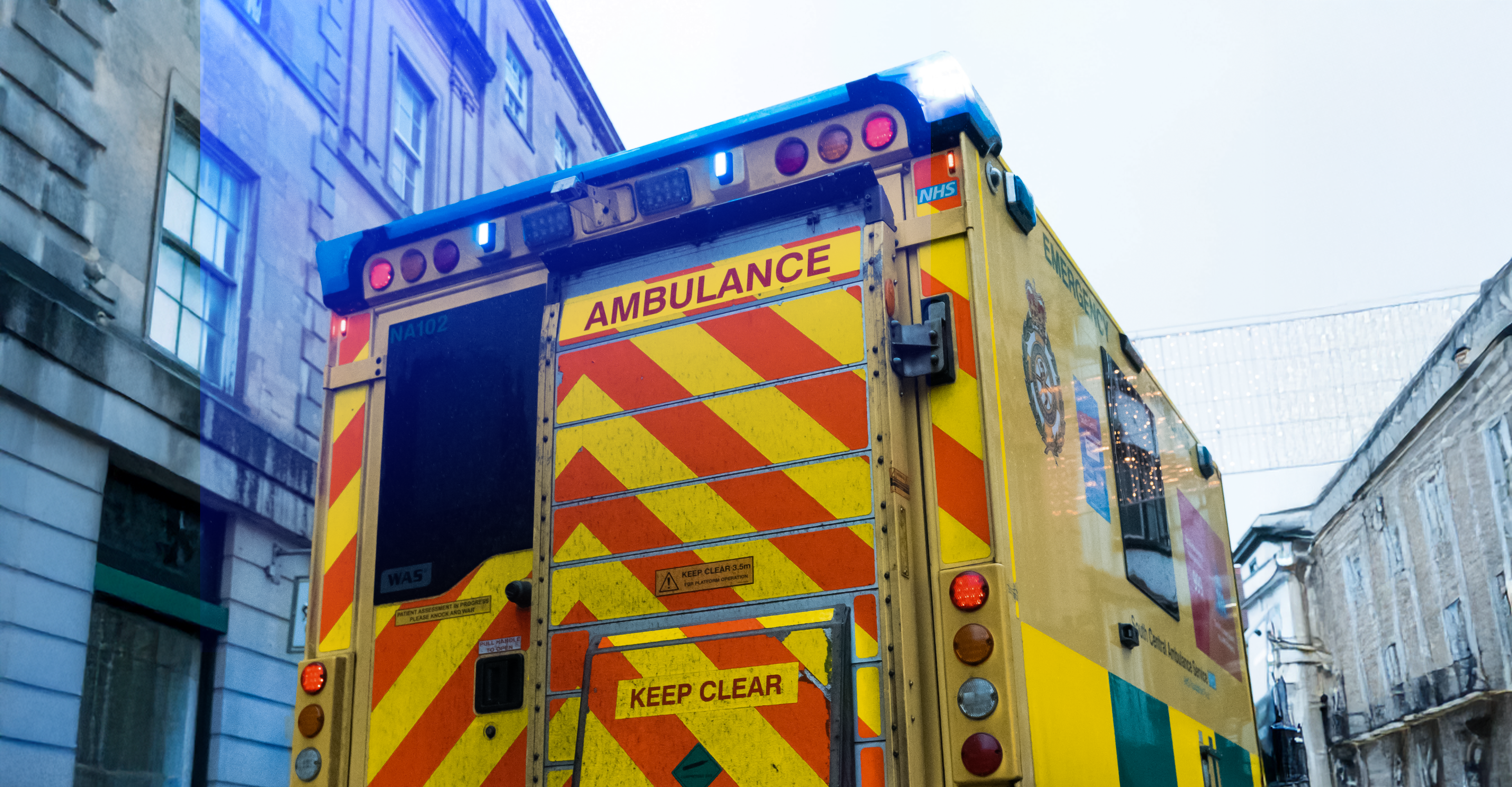 Photo of an NHS Ambulance with the siren or blue lights on.